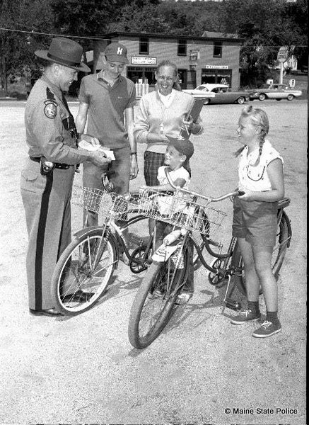 1959- Maine rooper Herman Boudreau performs bicycle inspections, Harrison, ME.