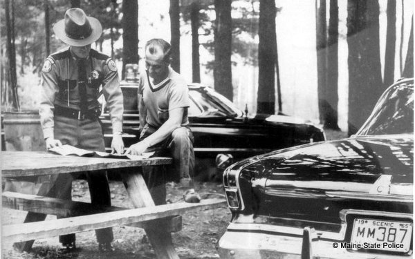 1965 summer - Trooper Jerald Boutilier reviewing map at Old Orchard Beach, ME.